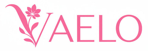 Pink VAELO logo with a stylized floral V on a plain white background.